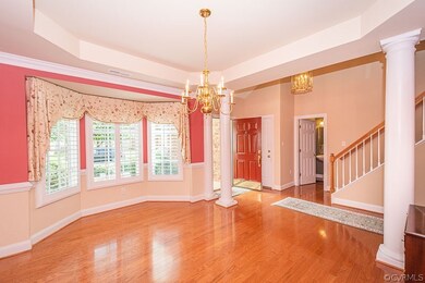 Dining room open to the foyer, separated by column