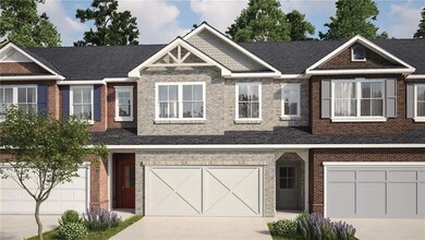 View of front facade with a garage, driveway, and brick siding