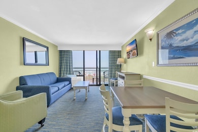 Living room with a wall of windows, crown molding,