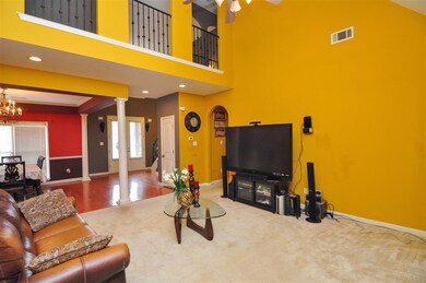 The great room opens to the foyer and dining room 