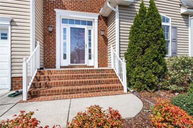 Brick front steps, front door with transom window