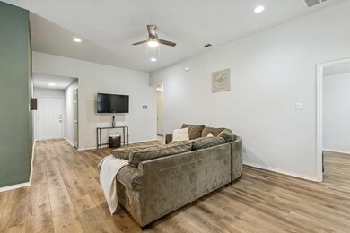 Living room featuring baseboards, light wood finis