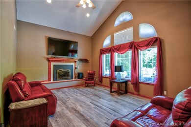 The living room has large windows to allow in plen