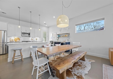 Dining space with finished concrete flooring, rec