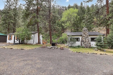 View of front of property featuring an outdoor fire pit, an outbuilding, and a chimney