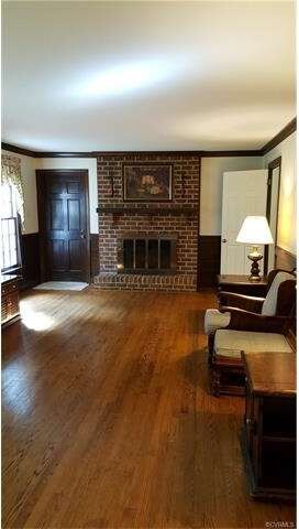 Family room with raised hearth fireplace, door to 