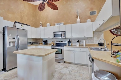 Kitchen with stone tile floors, butcher block coun