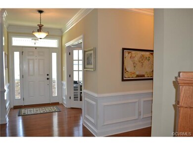 Foyer with transom and sidelight windows, wainscot