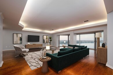 Living room with visible vents, a tray ceiling, ba