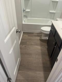 Full bathroom featuring vanity,  shower combination, and dark wood finished floors