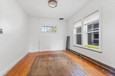 Spare room featuring wood-type flooring