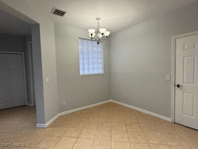Spare room with light tile patterned floors, baseb