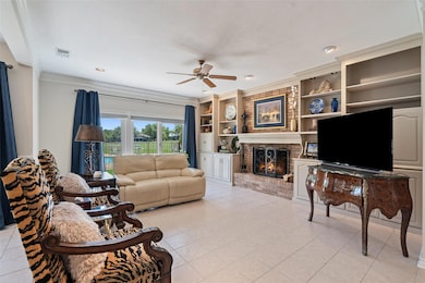 Living area with ornamental molding, a fireplace,