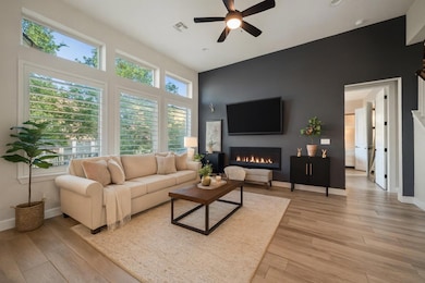 Living room with a glass covered fireplace, light