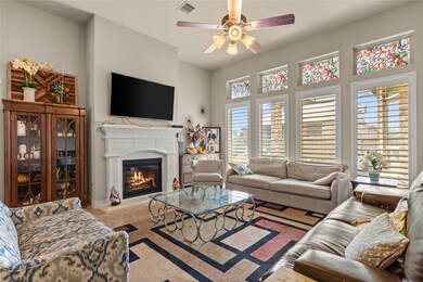 Gather the family and guests together in your lovely living room! Featuring high ceilings, dark stained ceiling fan with lighting, custom paint, gorgeous floors, fireplace with mantel and large windows that provide plenty of natural lighting throughout the day.