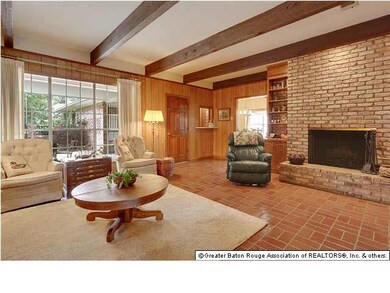 Den with fireplace & windows to view the patio