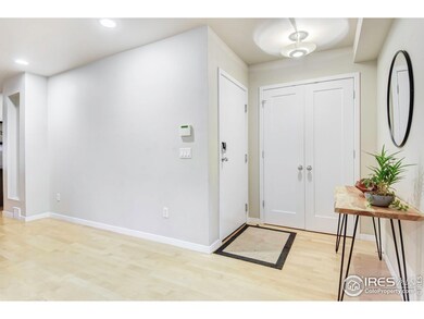 Foyer w/ large coat closet, maple floors & neutral palette