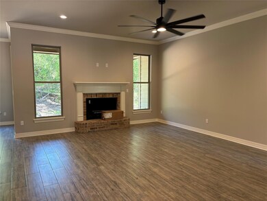 Unfurnished living room with a brick fireplace, da
