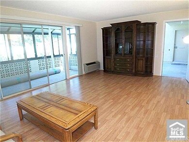 Living room is large and roomy, slider out to pati