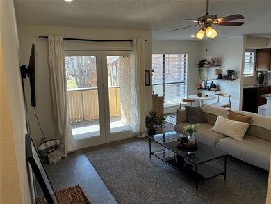 Tiled living room with a textured ceiling, ceiling