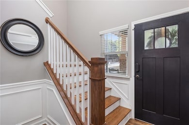 Entrance foyer featuring stairway, a decorative wa