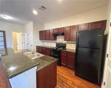 Kitchen with a sink, visible vents, backsplash, un