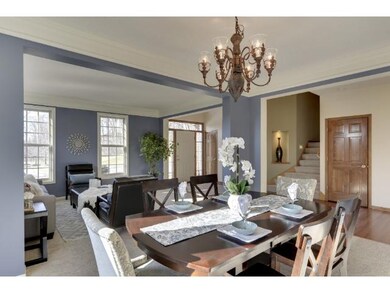 The formal dining room is open with the formal liv