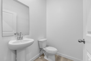 Bathroom featuring toilet and light wood finished floors