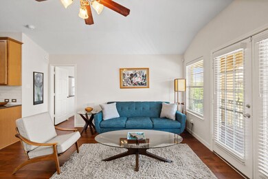 Living area with lofted ceiling, a ceiling fan, d
