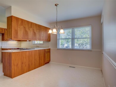 An eat in kitchen overlooks the backyard.