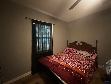 Bedroom featuring baseboards, a ceiling fan, and w