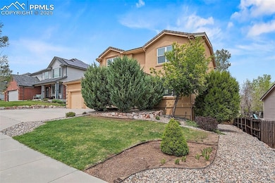 View of property hidden behind natural elements featuring stucco siding, driveway, and a garage