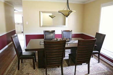 Elegant dining room with a lovely light fixture an