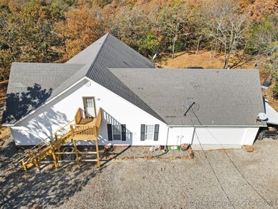 Back of home with stairs and deck to second level
