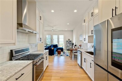 Kitchen featuring open floor plan, wall chimney ex