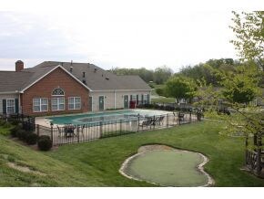 view of pool and putting gree
