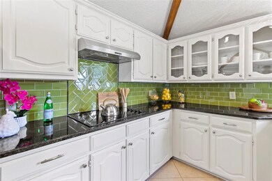 Glass cooktop, granite counters, decorative glass 