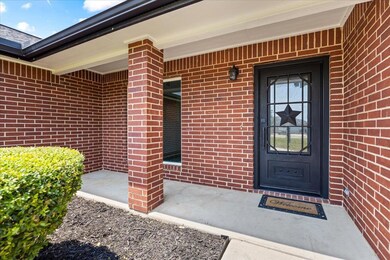 Doorway to property featuring brick siding and a 