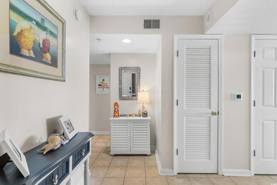 Hallway featuring light tile patterned flooring