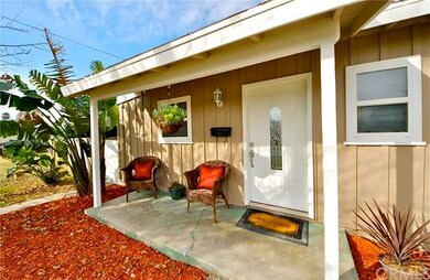 Covered porch entryway with newer front door