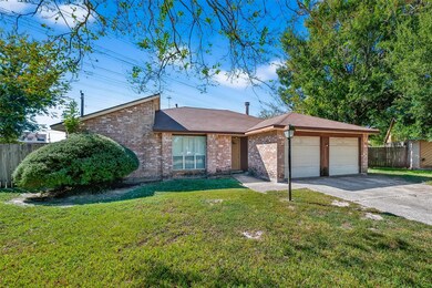 View of front of home with an attached garage, driveway, brick siding, and roof with shingles