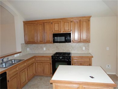 Tile Backslash & Black Appliances