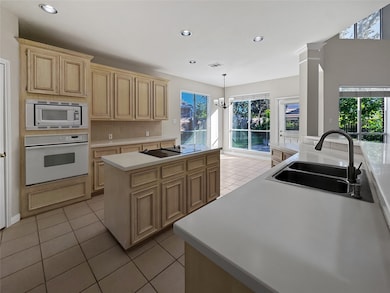 Kitchen with breakfast area and patio door to large patio.