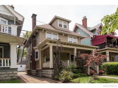 Exterior Front Beautifully landscaped yard on a lo