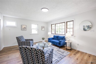 Living area featuring wood finished floors, plenty of natural light, and a textured ceiling