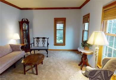 Formal living room with bright windows.