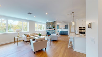 OPEN CONCEPT LIVING ROOM WITH LARGE WINDOWS