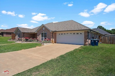 Ranch-style home with a front lawn, concrete drive