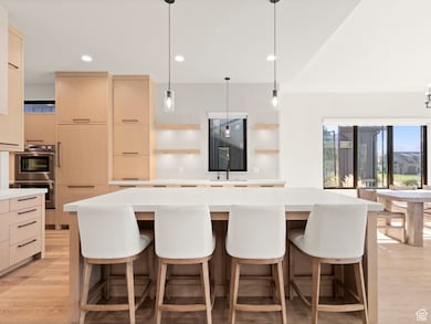 Kitchen with pendant lighting, open shelves, light wood-style floors, and recessed lighting