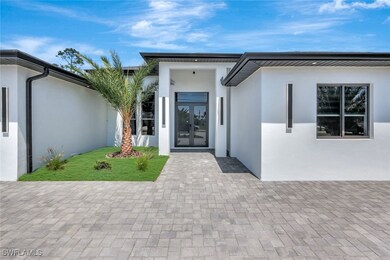 Property entrance with stucco siding and french do